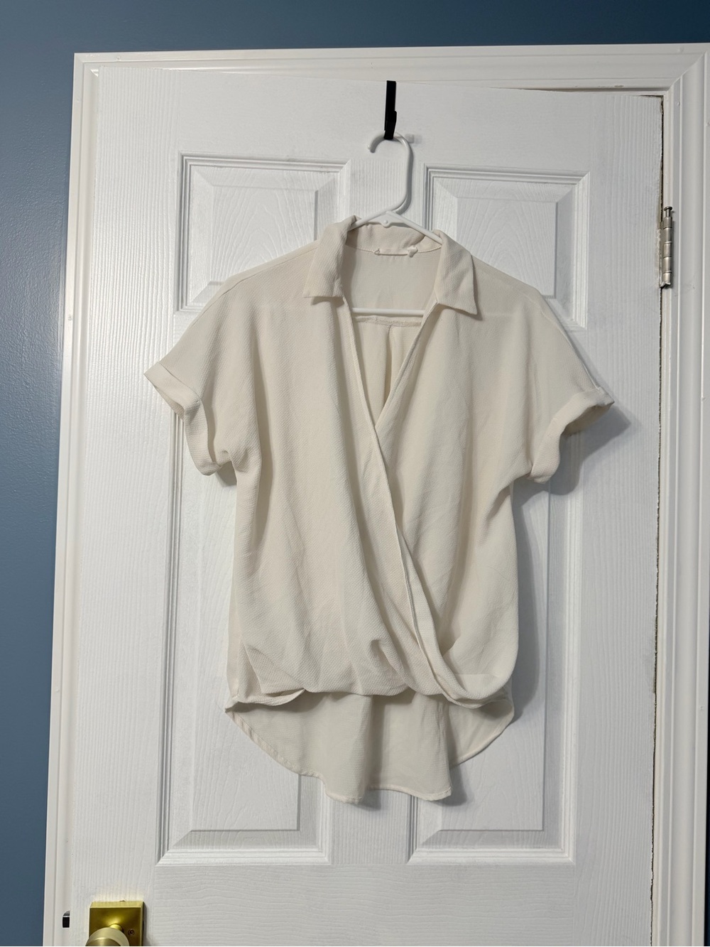 Lush white short sleeve blouse with longer back and v neck draped front. Small s